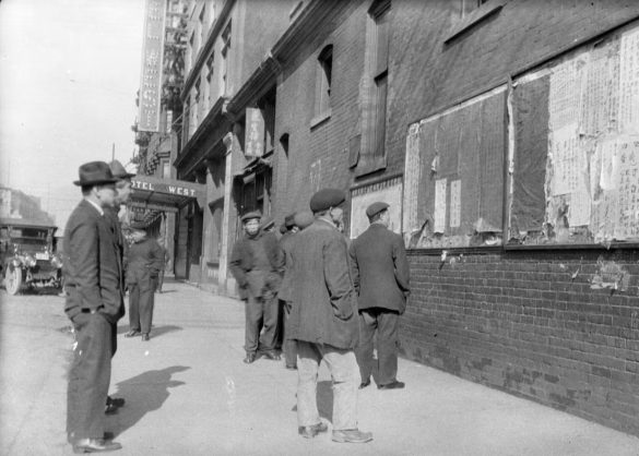 Vancouver residents read bulletin boards on the side of the Chinese Times building at 1 E. Pender St. circa 1926. (City of Vancouver Archives (AM640-S1-: CVA 260-1575))
